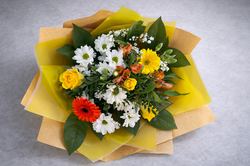 Bouquet of flowers with yellow, white, and red flowers on a gray background